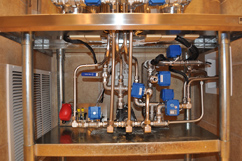 Plumbing under tanks